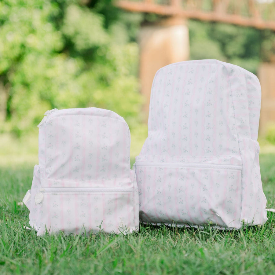 TRVL Mini Backpacker and The Bakerpacker in the Ribbon Floral Pink Print.