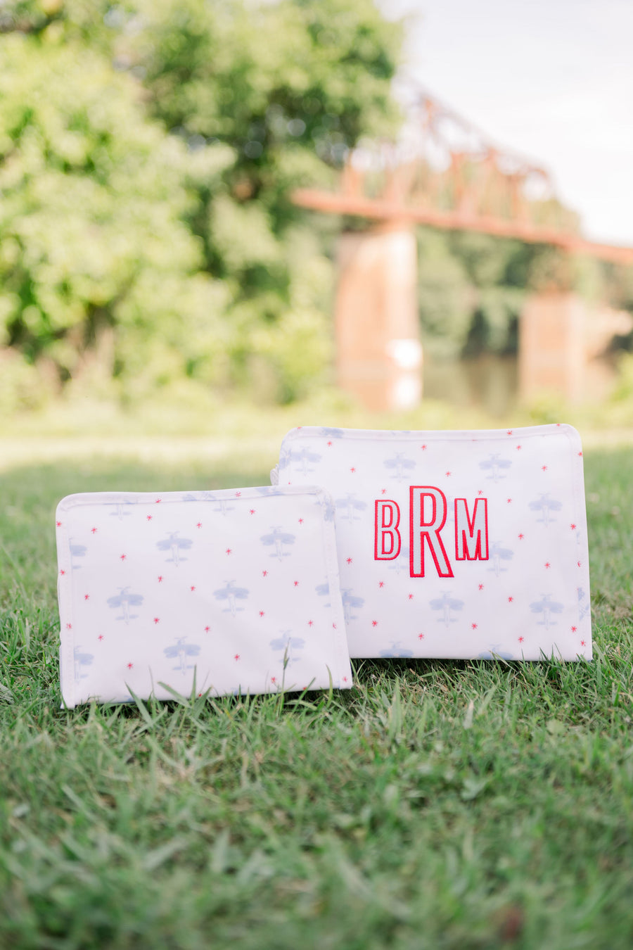 TRVL Medium and Large Roadie side by side with BRM embroidered on the large roadie in red and light blue