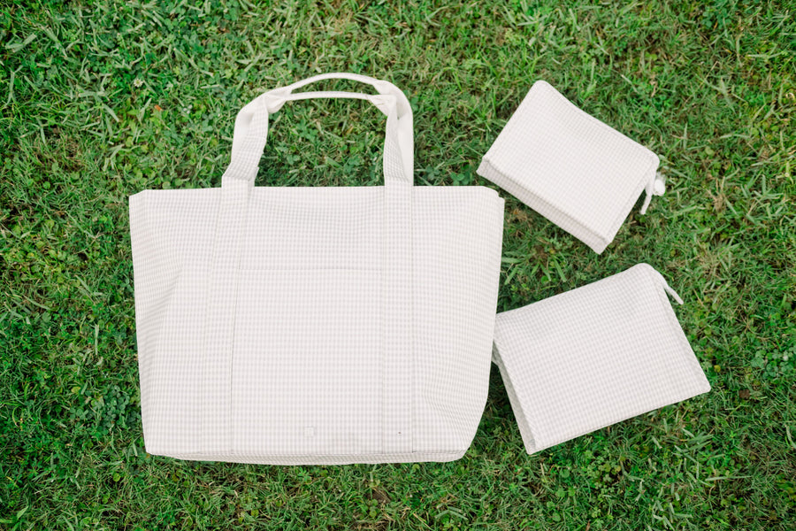 TRVL Jumbo Tote with 2 different-sized TRVL Roadies on the right side