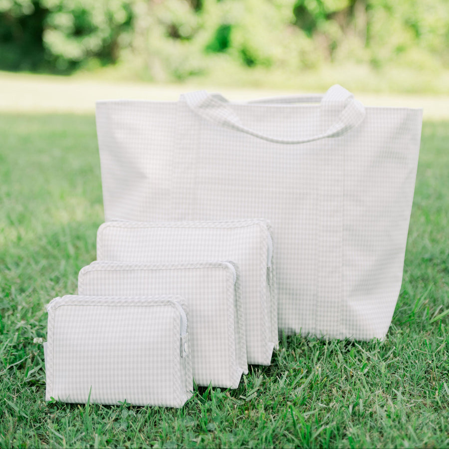 TRVL Jumbo Tote with 3 different-sized TRVL Roadies in front