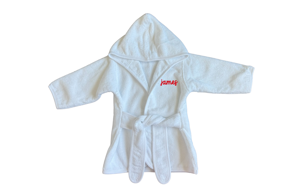 The classic terry cloth robe flatlay with 'james' embroidered on the left chest in red.